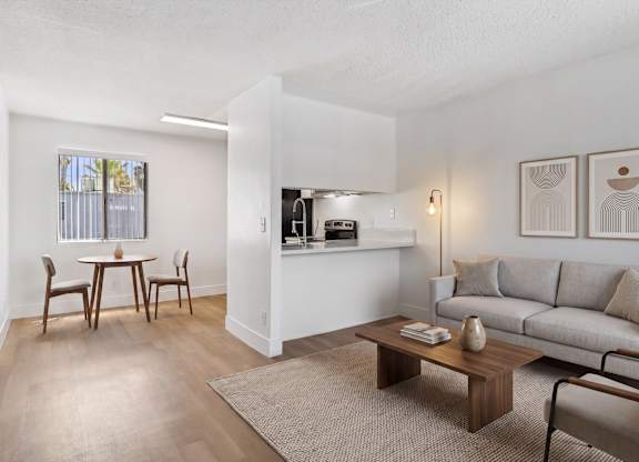 A living room with a dining table and chairs.