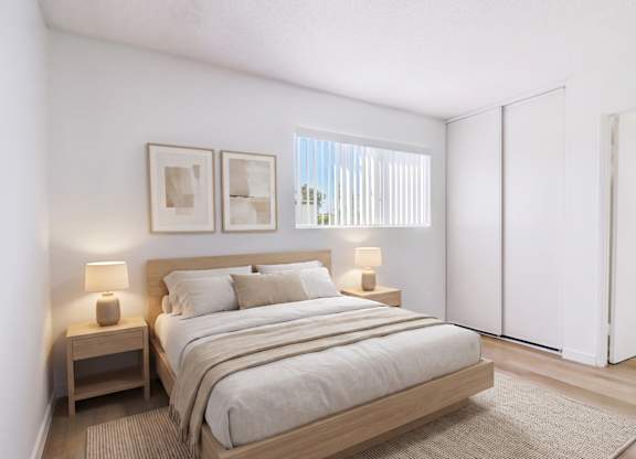 A bedroom with a large bed and two nightstands.