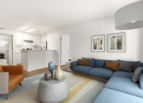 A living room with a grey couch and a grey coffee table with a blue couch and orange pillows.