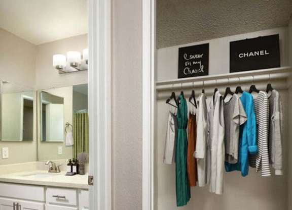 Clothes hanging on a rack in a room.