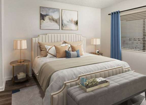 A bedroom with a large bed and two lamps.