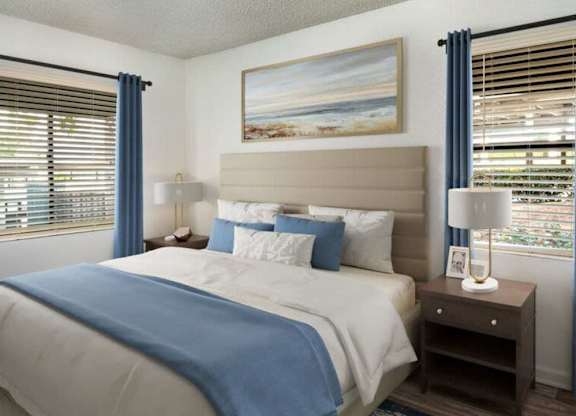 A bedroom with a large bed and a painting on the wall.