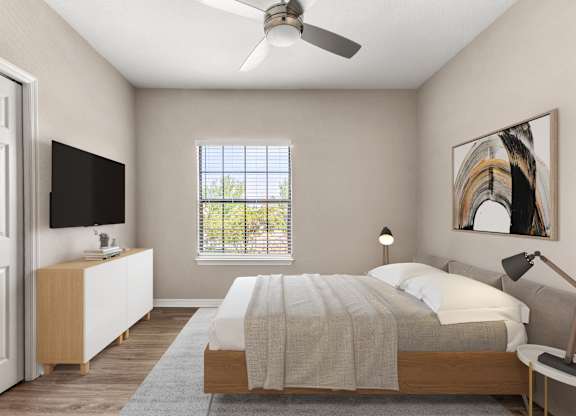 A bedroom with a bed, a television, a window, and a painting on the wall.