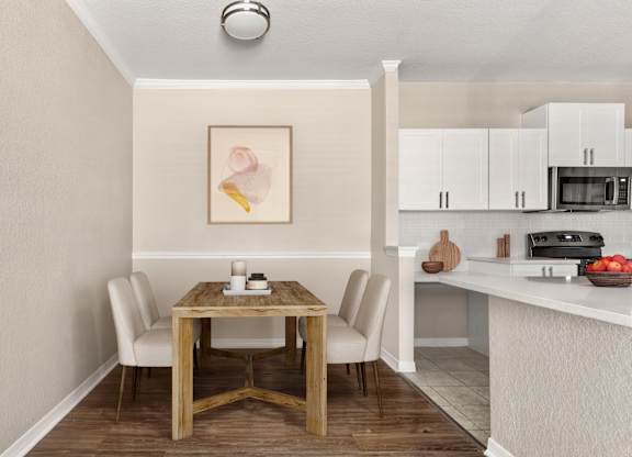 A dining table with chairs and a painting on the wall.