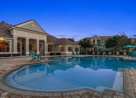 A large house with a pool in the backyard.
