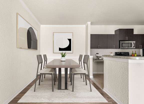 A dining table with chairs and a framed picture on the wall.