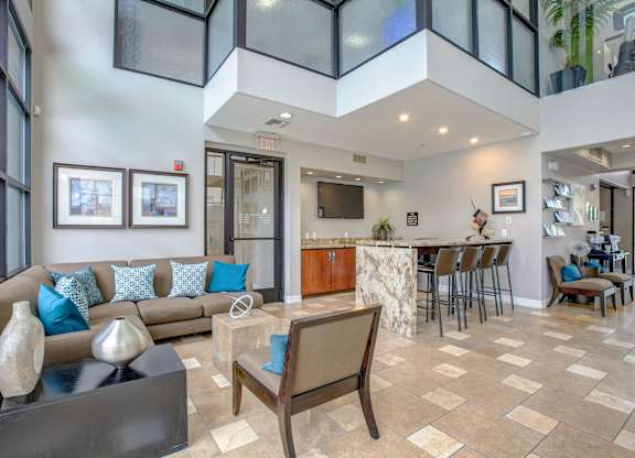 A living room with a couch, chairs, and a coffee table.