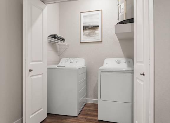 A small laundry room with a washer and dryer.