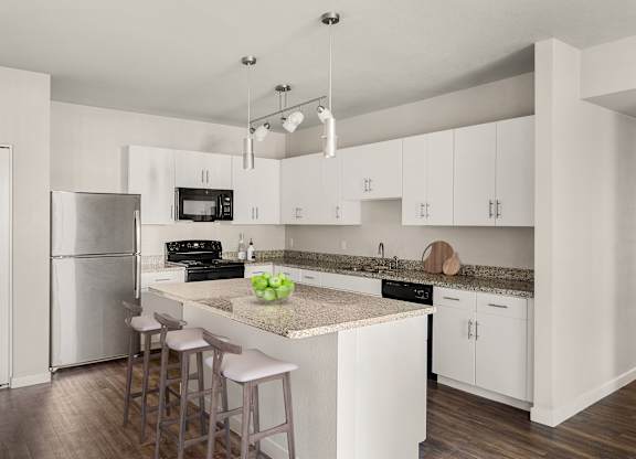 A kitchen with white cabinets and a granite countertop.