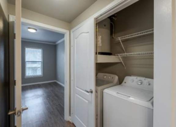 A small laundry room with a washer and dryer.