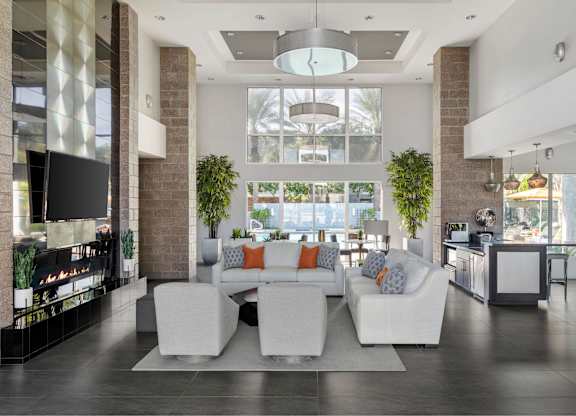 A modern living room with a white couch and a fireplace.
