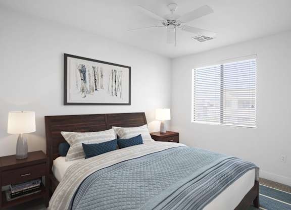A bedroom with a bed, nightstands, and a ceiling fan.