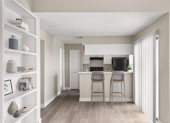 A kitchen with a bar stool in front of it.