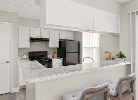 A kitchen with a refrigerator, oven, and stove.