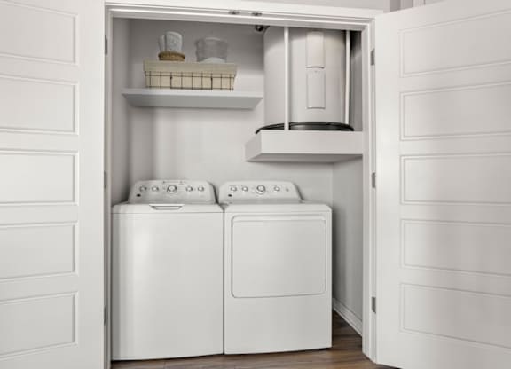 A white laundry room with a washer and dryer in it.