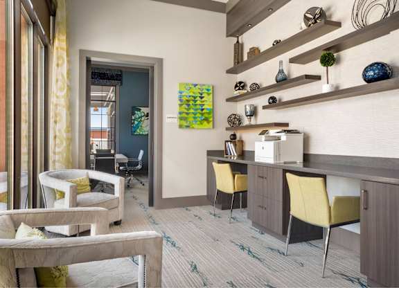 A modern living room with a grey sofa and yellow chairs.