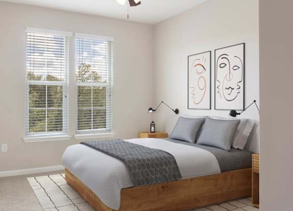 A bedroom with a bed, a television, and a window with blinds.