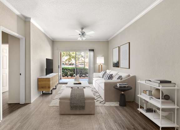 A living room with a couch, a coffee table, and a television.