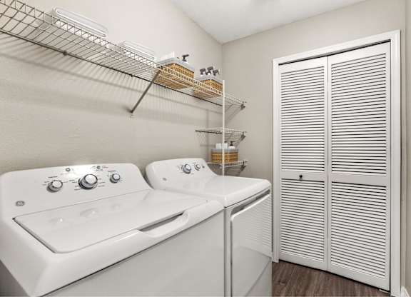 A white washer and dryer in a laundry room.