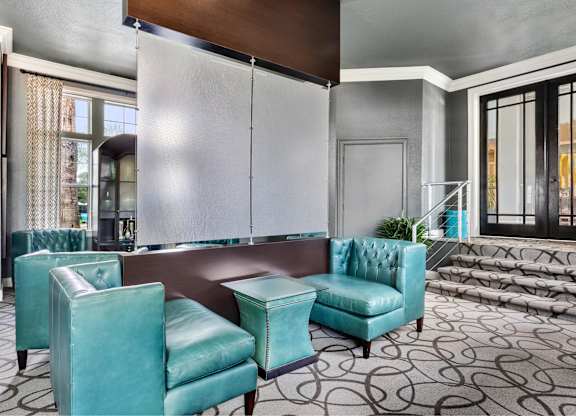 A room with a blue chair and a brown table.