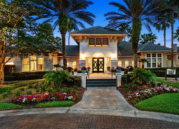 A beautiful house with a front yard and a driveway.