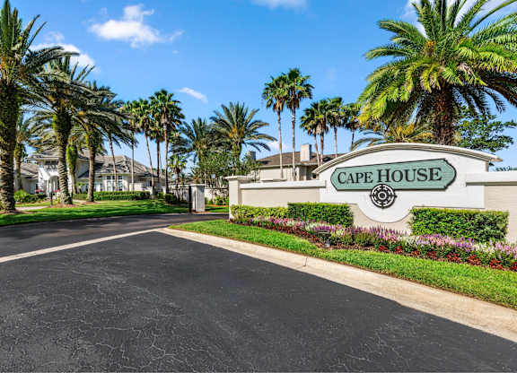 A street view of Cape House with palm trees on the side.
