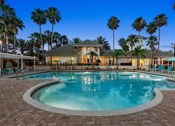 A large house with a pool in front of it.