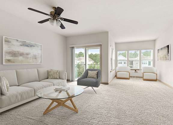 A living room with a grey couch, a glass coffee table, and a ceiling fan.
