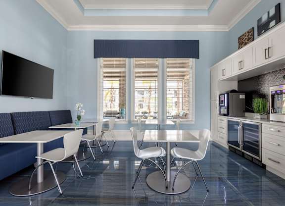 A modern kitchen with a dining table and chairs.