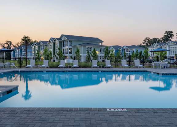 A swimming pool in front of a building with a number 133 on the ground.