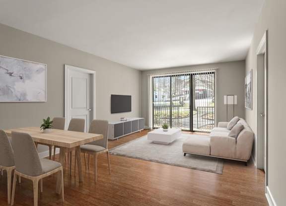 A modern living room with a wooden table and chairs, a white sofa, and a television.