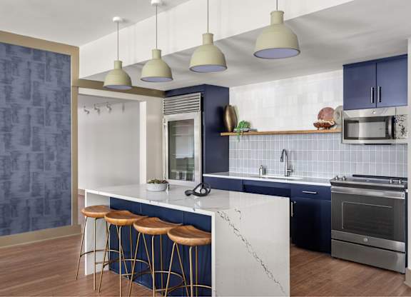 A modern kitchen with a bar area and a blue backsplash.