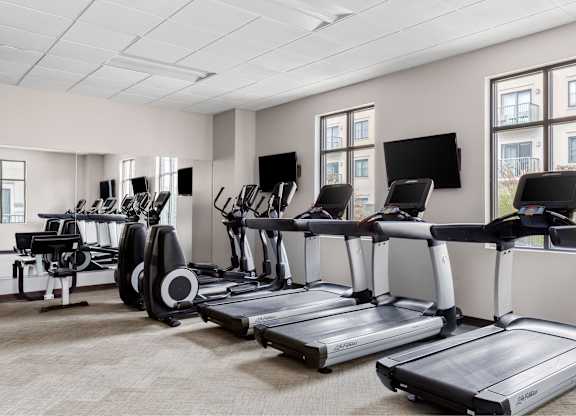 A gym with treadmills and exercise bikes.