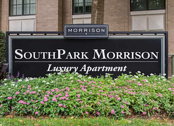 A sign for SouthPark Morrison Luxury Apartment in front of a building.