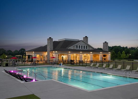 A large house with a pool in front of it.
