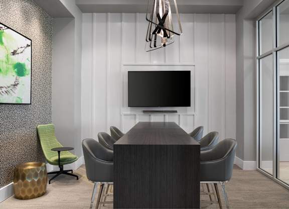 A conference room with a long table and chairs.