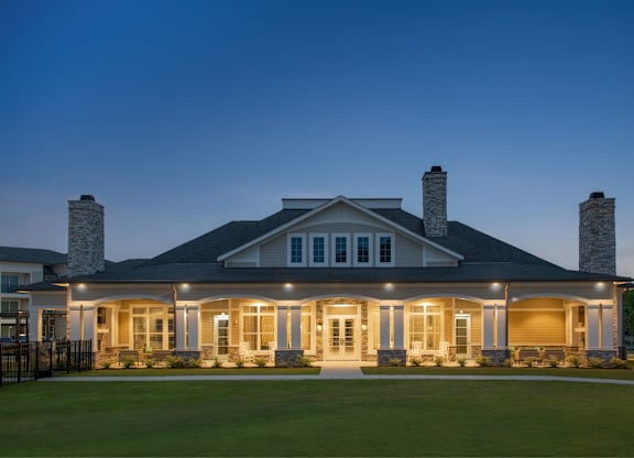 A large house with a front porch and two chimneys.