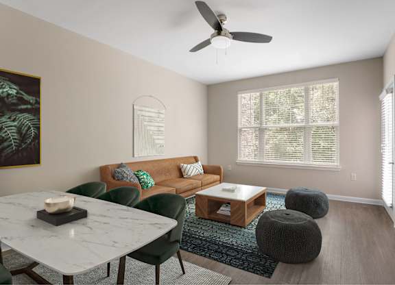 A living room with a couch, chairs, and a coffee table.