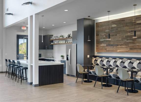 A modern kitchen with a bar area and seating.