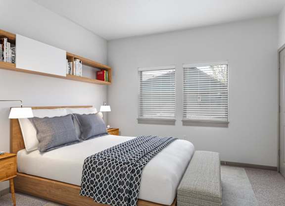 A bedroom with a bed, nightstand, and window with blinds.