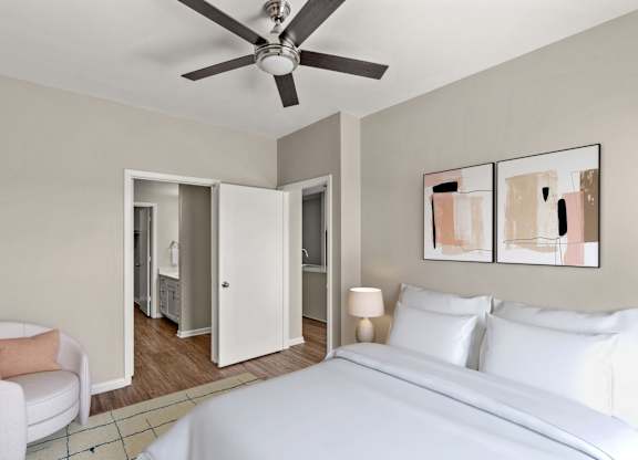 A bedroom with a white bed and a ceiling fan.