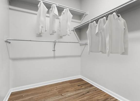 A row of white shirts hanging on a clothesline.