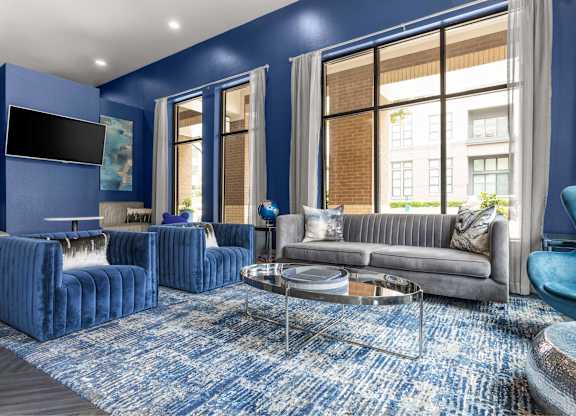A living room with blue walls and furniture.