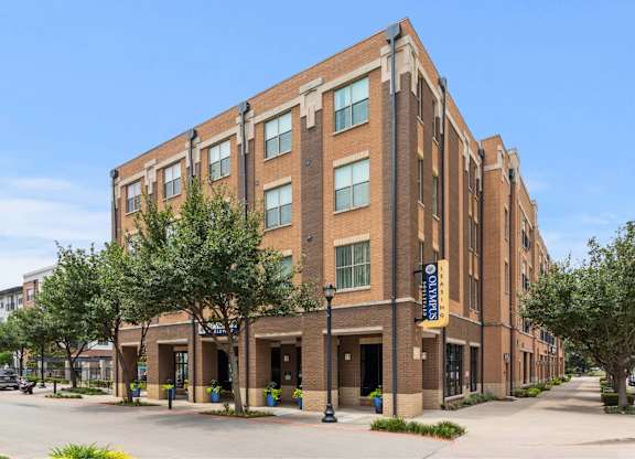 A large brick building with a yellow sign on the front.