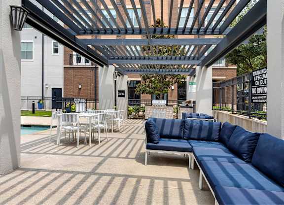 A patio with a blue couch and a pool table.