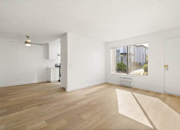 A room with wooden floors and white walls.