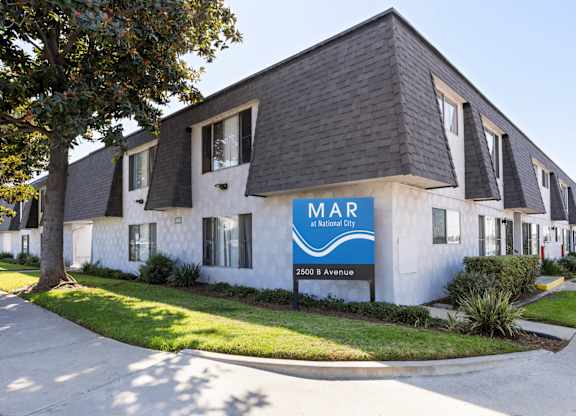 A white building with a blue sign that says MAR on it.