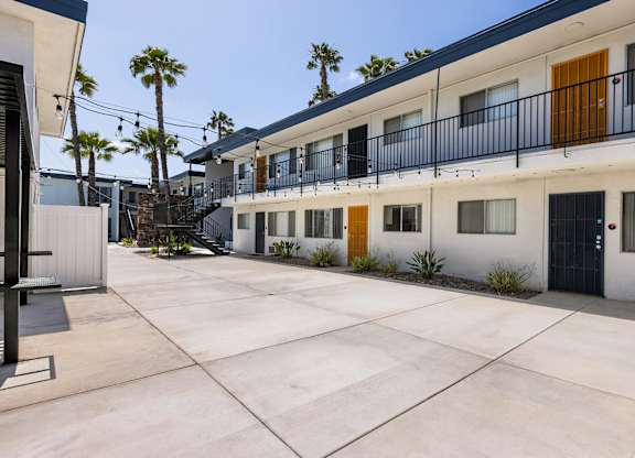 A sunny day at a modern apartment complex with a courtyard.