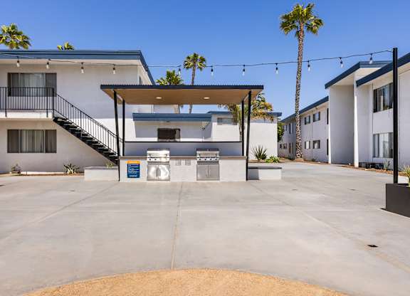 A modern house with a white exterior and a brown door.