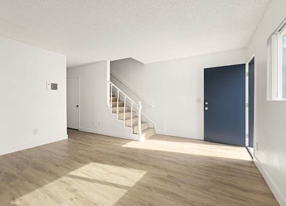 A room with a staircase leading to another room.